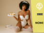 AI-generated portrait of a smiling woman with curly hair wearing a white lace bodysuit and thigh-high stockings, posing on a beige studio backdrop while holding a tray with cupcakes and a drink in a playful pin-up inspired scene.
